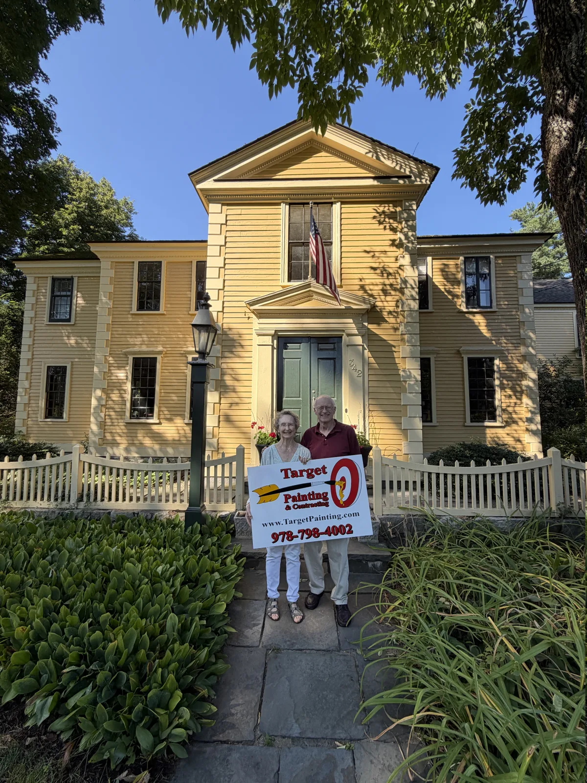 Homeowners in front of the Daniel Chester French House after Target Painting exterior painting and carpentry work in Concord