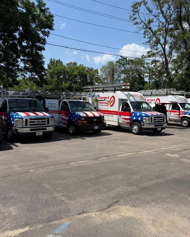 A row of Target Painting work vans parked in a lot