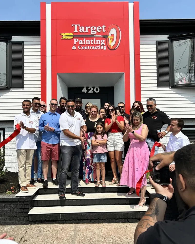 The Target Painting team celebrating a ribbon cutting outside the Target Painting & Contracting office